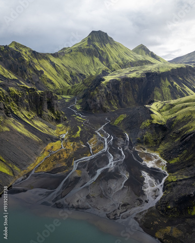 Vertical aerial view on a green mountain with glacial streams flowing from it, Highlands Iceland