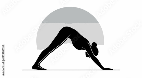 Woman practicing yoga in downward facing dog pose.