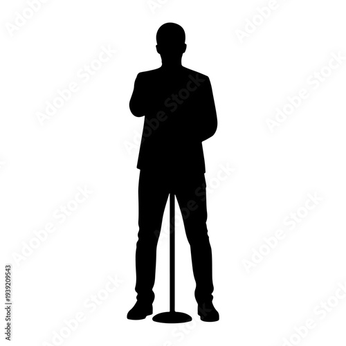 Silhouette of a man standing at a microphone.