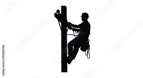 Lineman working on utility pole depicted as a striking silhouette