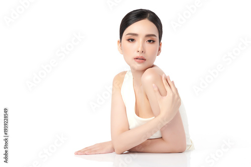 A beautiful young Asian woman with clean, fresh skin against a white background. Skincare, facial treatment, cosmetology, beauty, and spa. An elegant portrait of an Asian woman.