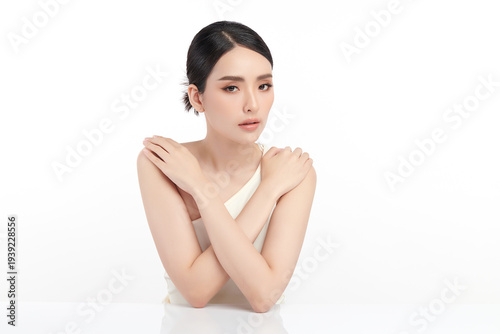 A beautiful young Asian woman with clean, fresh skin against a white background. Skincare, facial treatment, cosmetology, beauty, and spa. An elegant portrait of an Asian woman.
