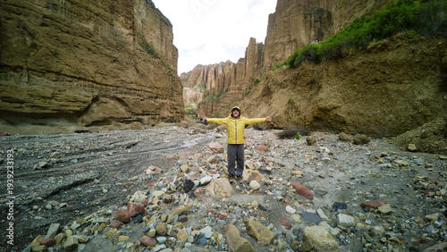 972d9f8c-Man in Yellow Jacket Standing in Palca Canyon, La Paz, Bolivia