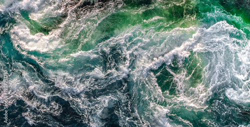 Blue waves of water of the river and the sea meet each other during high tide and low tide.