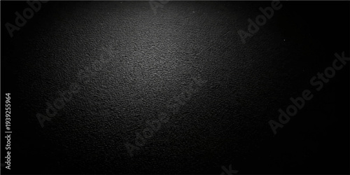 Abstract a dark textured backdrop, with a subtle light gradient. Its dark elegance lends itself to a versatile range of design and artistic projects. 