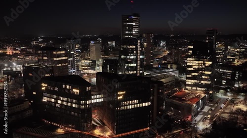 Wallpaper Mural Drone aerial panorama of Vilnius skyline at dusk with illuminated office buildings, modern business district, and city lights under twilight sky in Lithuania. Torontodigital.ca