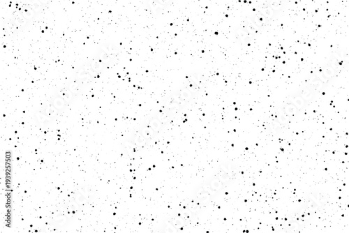 Countless tiny black speckles randomly scattered across a clean bright white surface creating a distressed texture