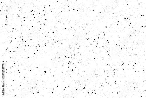 Numerous tiny black spots are randomly scattered across a bright clean white canvas creating a subtle grain