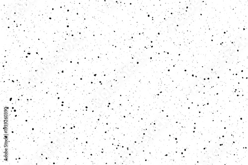 Scattered tiny black speckles randomly dotting a bright white surface creating a distressed overlay effect