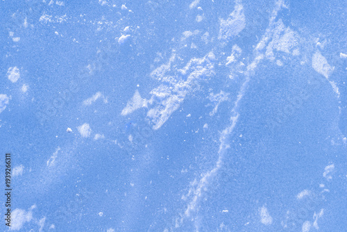 Blue rough ice texture with snow, winter background