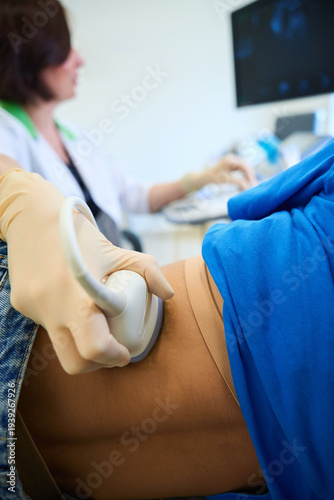 Female medical professional performing ultrasound examination indoors
