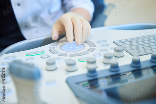 Focused woman operating medical imaging device in examination room