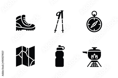 Black hiking gear including boots, trekking poles, compass, map, water bottle, and camp stove