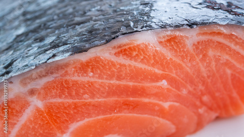 Salmon fillet captured up close in brilliant detail. The scales and the bright orange flesh fills the frame in a stunning way. Food inspired content.