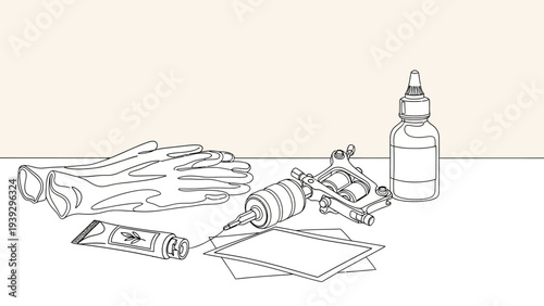 Tattoo machine, gloves, ink, and stencil laid out for tattooing.