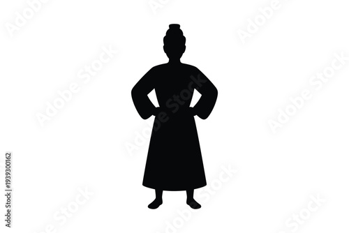 Silhouette of a woman in a long dress with hands on hips