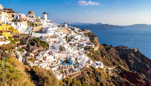Whitewashed village sprawls down a cliffside toward a blue sea, under a vibrant sky in scenic Santorini