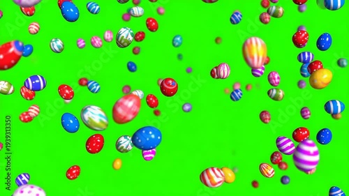 Many colorful patterned Easter eggs falling against a solid green screen chroma key background
