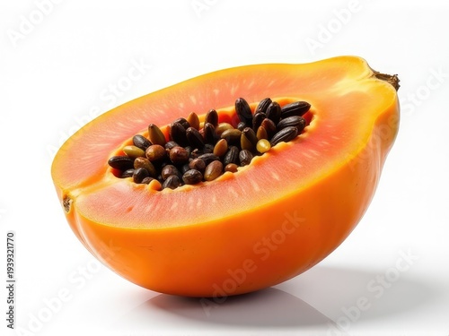 A fresh papaya cut in half on a white surface, ready for use or display
