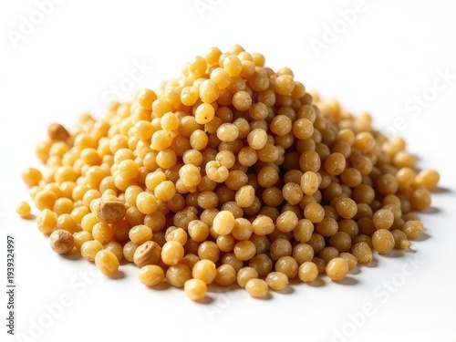 A pile of yellow grains on a white surface, suitable for use in still life or food-related compositions