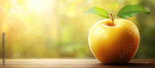 Golden apple on wood, sunlit garden backdrop, healthy food