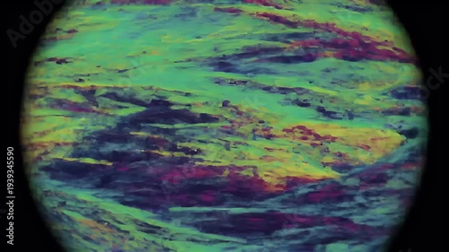The planet showcases swirling patterns of green, blue, purple, and yellow colors in space.