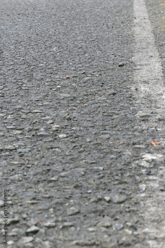 Closeup of asphalt road with white line marking