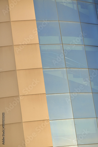 Modern building facade with blue and beige glass panels