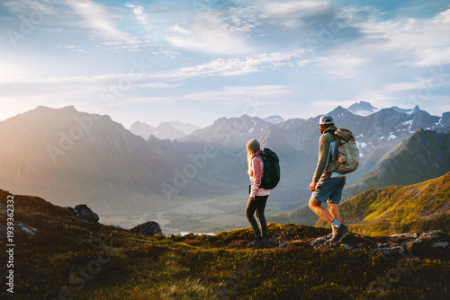 Couple hiking in Norway man and woman travel together in Lofoten islands, friends on active summer vacation healthy lifestyle family trekking outdoor adventure backpacking trip eco tourism