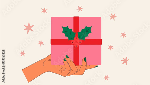 Festive pink gift box with holly and ribbon, held in a hand, surrounded by stars and snowflakes, perfect for holiday celebrations