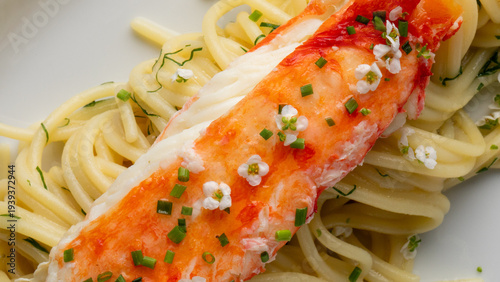 Elegant crab leg crowns al dente noodles with floral sprinkles, invoking Obon festivities and ephemeral cherry blossom viewing