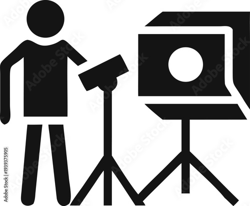 Person operating professional studio lighting equipment for a photography session setup