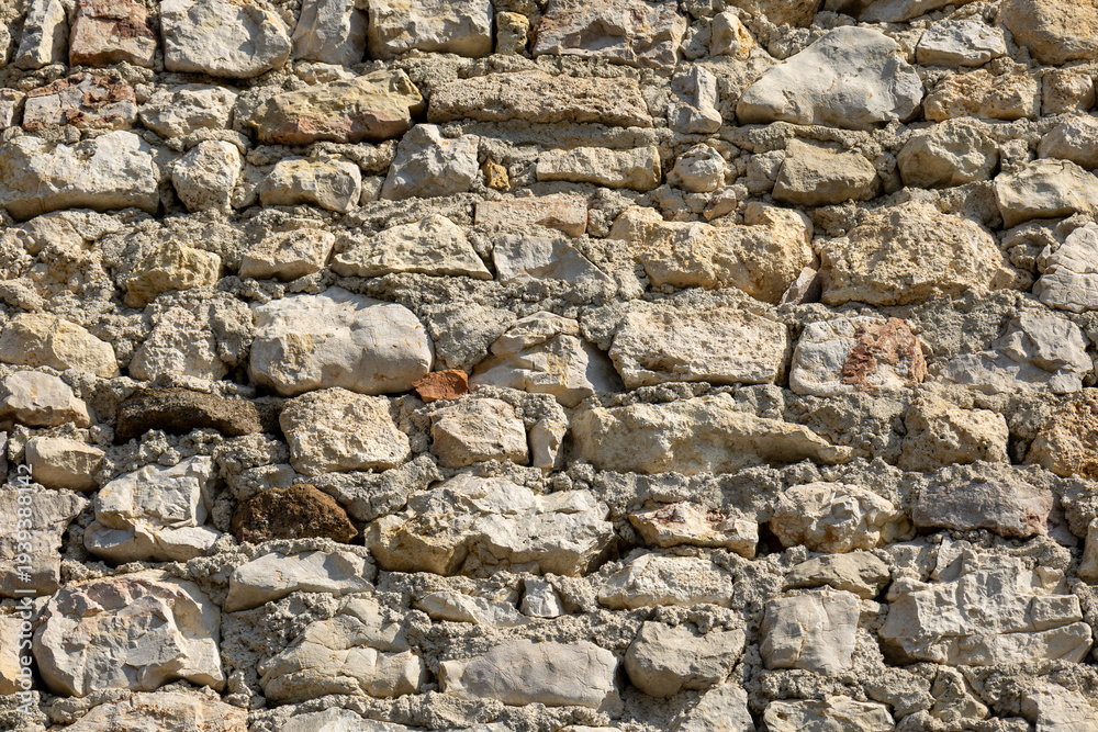 Fototapeta premium Rustic stone masonry wall texture close up background