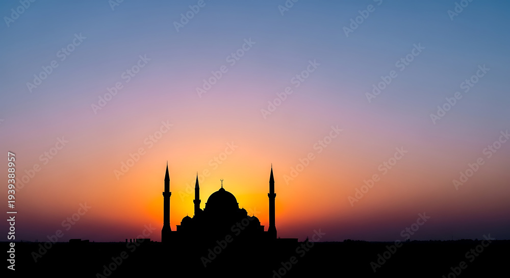Naklejka premium Serene mosque silhouette at vibrant sunset with colorful sky
