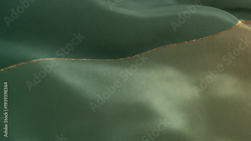 Abstract Luxury Sage Green and Gold Silk Background with Elegant Wavy Texture for Premium Branding and Cosmetics Packaging Design