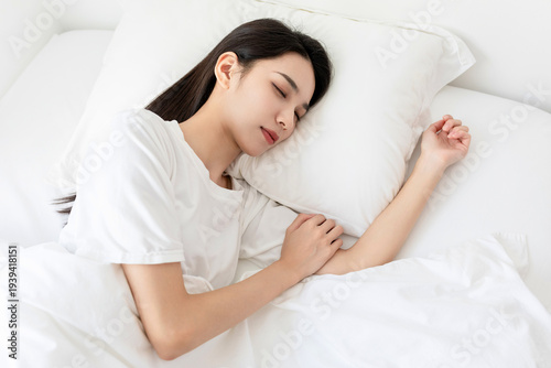 A young woman sleeping in the bed