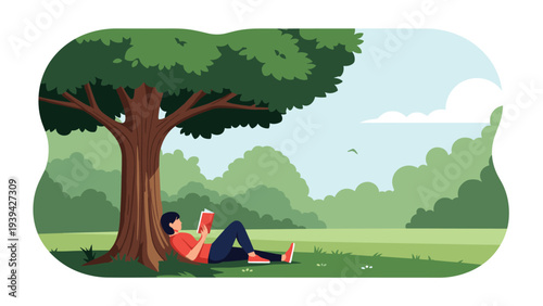 Peaceful scene of a person lying on the grass and reading a book under the shade of a large green tree in a quiet park.