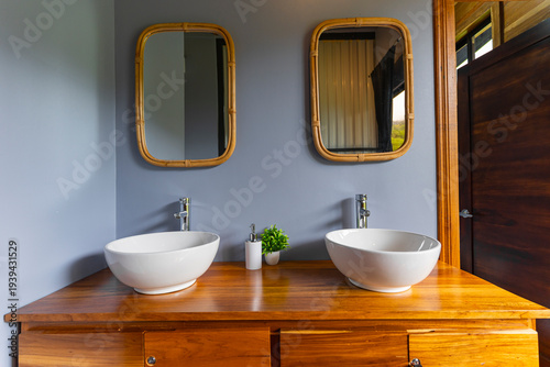 Bathroom vanity with two sinks and bamboo mirrors