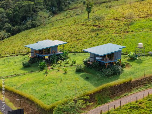 Modern bungalows nestled on green hillside in costa rica