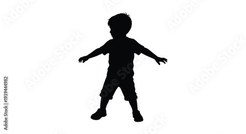 Young boy with arms outstretched depicted in dark silhouette