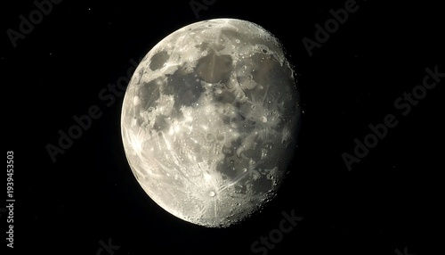 Waning gibbous moon shines, showing craters and texture against a stark black sky