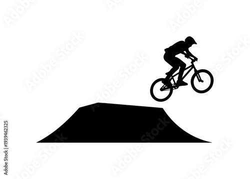 Vector silhouette of a mountain biker jumping over a ramp