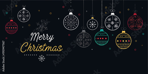 Festive christmas ornaments and a merry christmas greeting on black