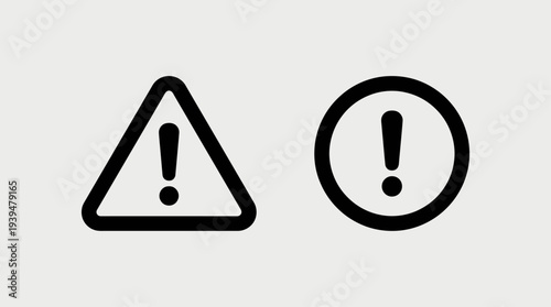 Two black outline warning icons, one triangular and one circular, both containing an exclamation mark, on a light grey background.