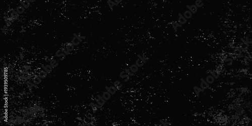 A dark grainy texture resembling a starry night or dust particles