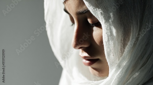 Serene contemplation: Portrait of a woman in a traditional white hijab