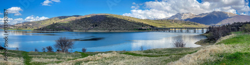 panoramic view on artificial lake of campotosto with hills and peak mountains...
