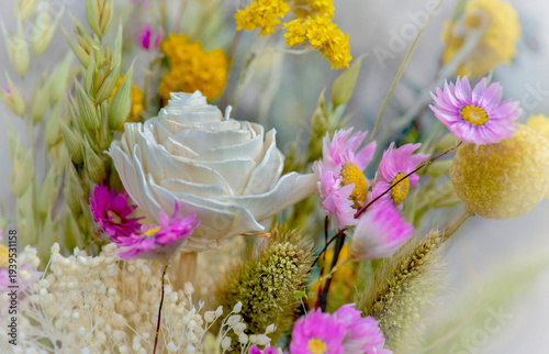 white rose in a romantic and summer dried bouquet of flowers with a blurred e...