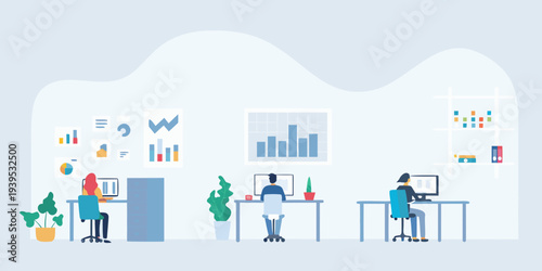 Modern office workspace with people working on computers and data charts