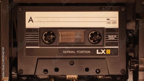 Retro radio tape recorder, audio cassette close-up. Listening to music, old radio boom box player, macro of vintage music listening. 